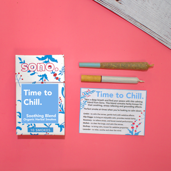 Image Description: A smoke pack lies next to its info card, 1 preroll & 1 cigarette, titled Time to Chill, an herbal smoke blend offered for sale by herbal apothecary, Sono Herbs. The cigarette box is white & blue & made with eco-friendly materials. There are blue designs on the white box, silhouettes of herbs & flowers, the ingredients: Marigold, Klip Dagga, Rosemary, Mullein, Skullcap & Lavender. Herbal smokes are also known as Herbal Spliffs, Herbal Cigarettes, Herbs & Flowers Prerolls, or Herb Tokes.